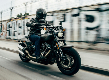 A picture of a man riding a motorcycle on the road