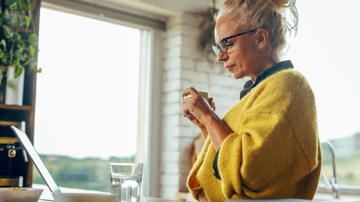 A woman looking at holiday home insurance on her laptop