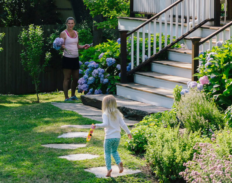 Mother and daughter in front of the house