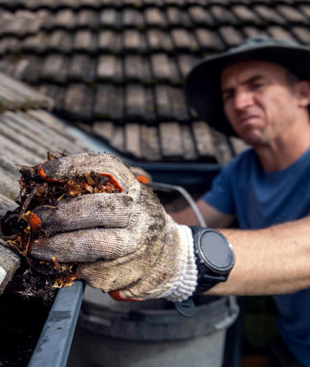 Man cleaning gutters.