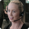 A friendly looking woman wearing a telephony headset.
